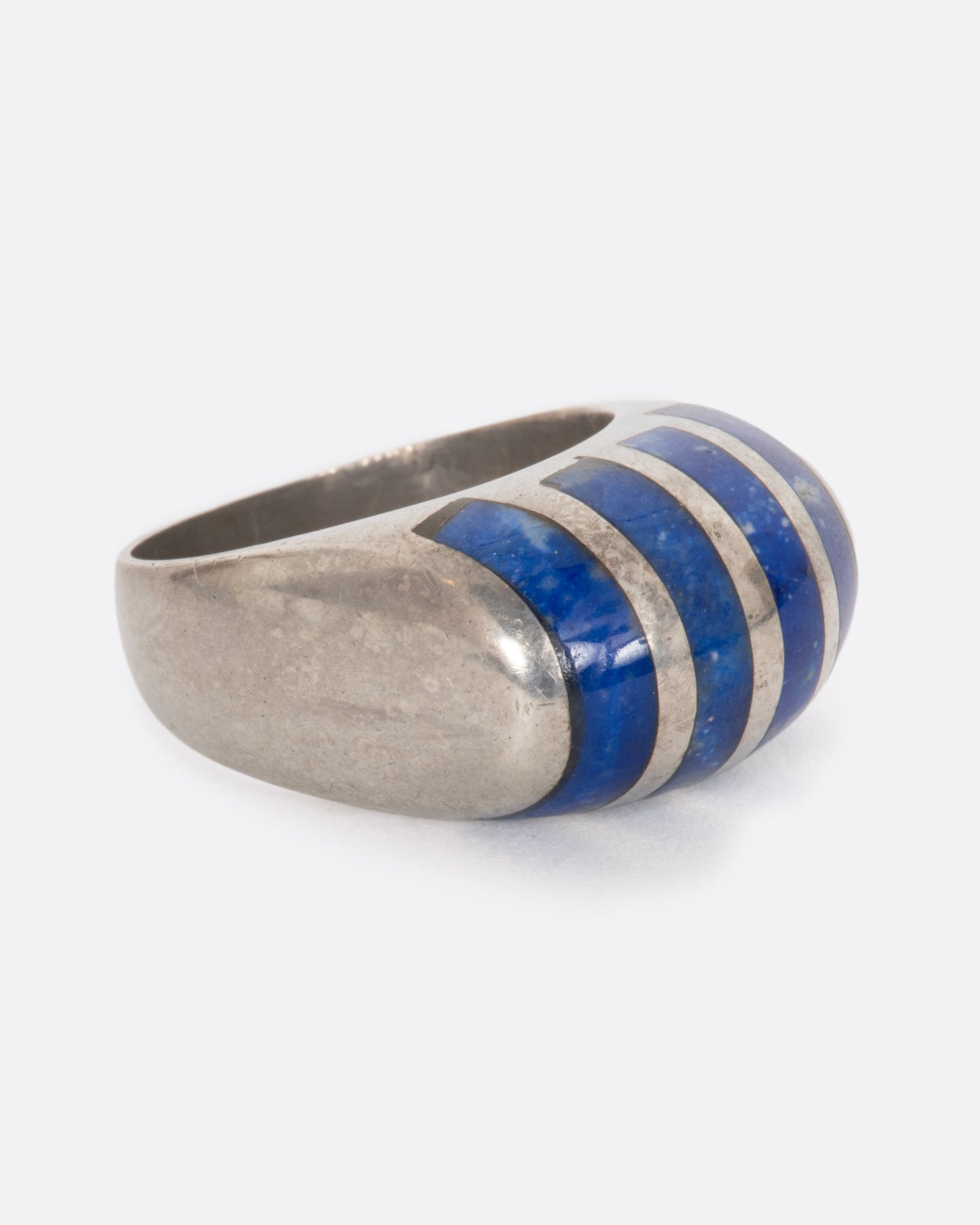 A sterling silver ring with four lapis sections. View from the side.