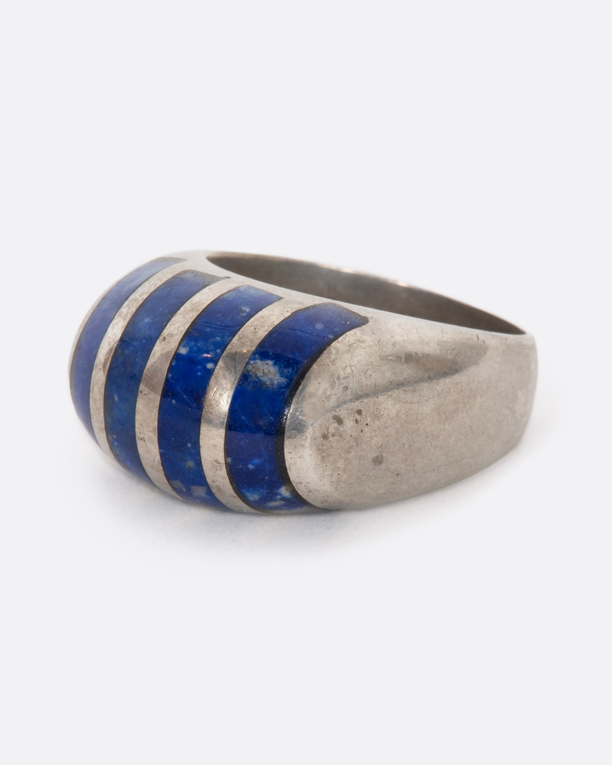 A sterling silver ring with four lapis sections. View from the side.