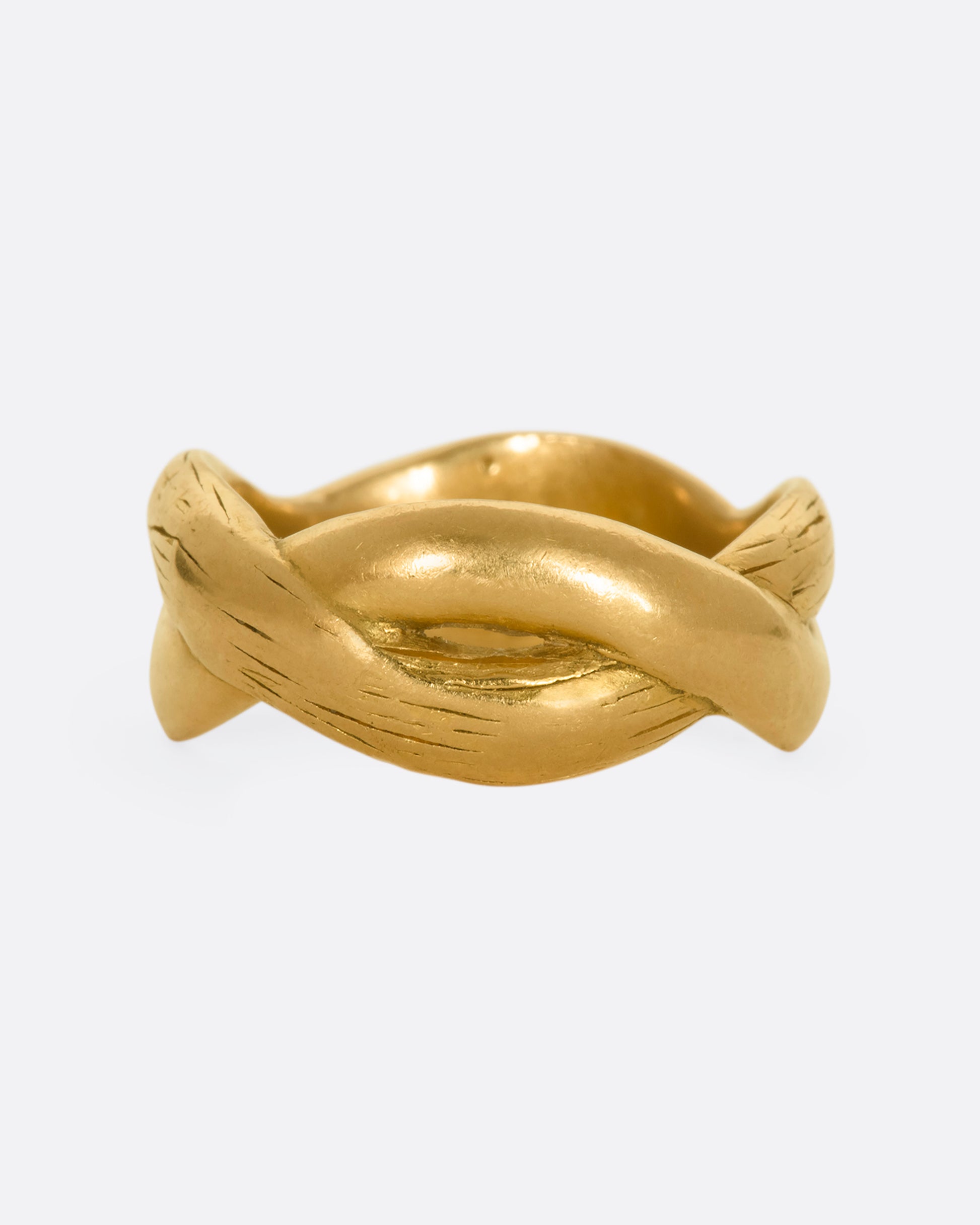 A yellow gold twisted band with engraving.