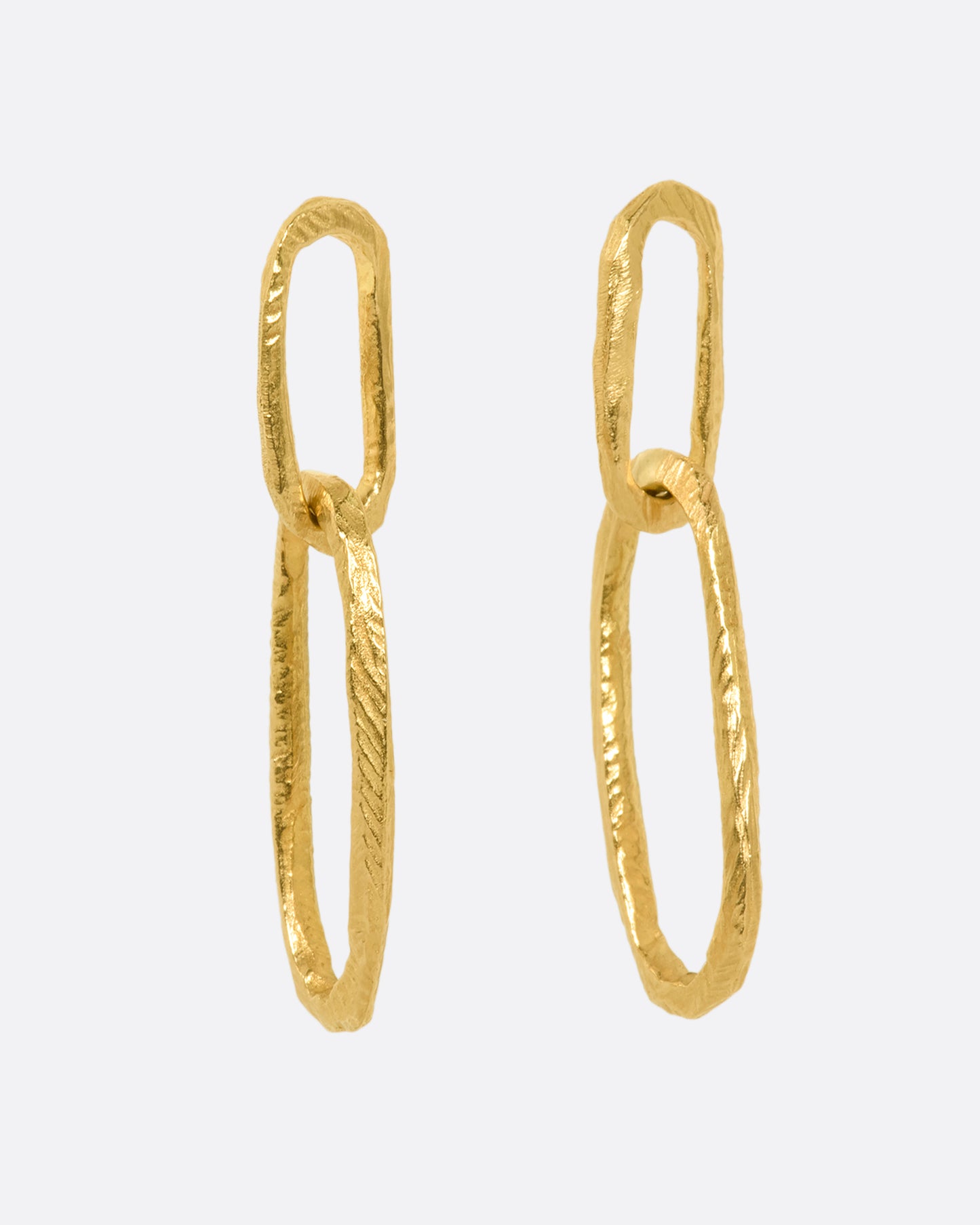 Yellow gold textured oval link earrings with stud backings. View from the side.