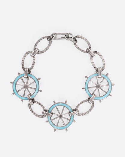 Vintage chain bracelet in sterling silver, oval links joined by three ship steering wheels in light blue enamel