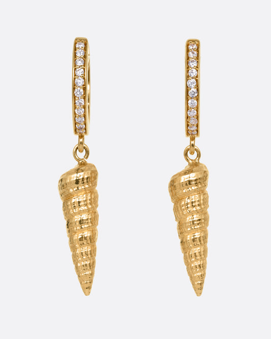 A pair of yellow gold diamond lined hoop earrings with seashell drops. Shown from the front.