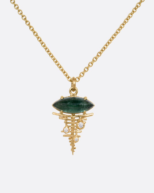 A yellow gold cable chain necklace with a deep green tourmaline cabochon at the top of a diamond studded gold lattice. Shown from the front.