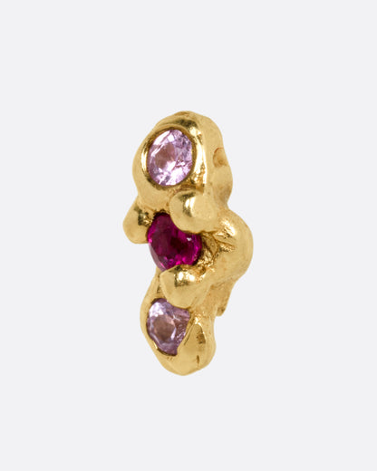 Yellow gold pink and red sapphire stud earrings, close view of one stud