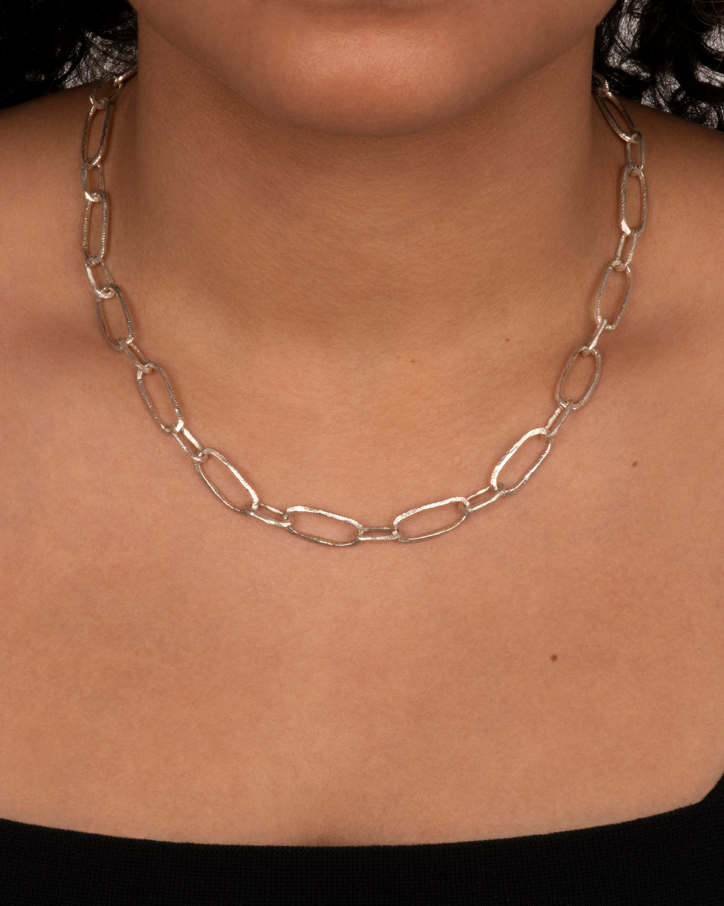 Sterling silver hand carved chain necklace. View on a neck.