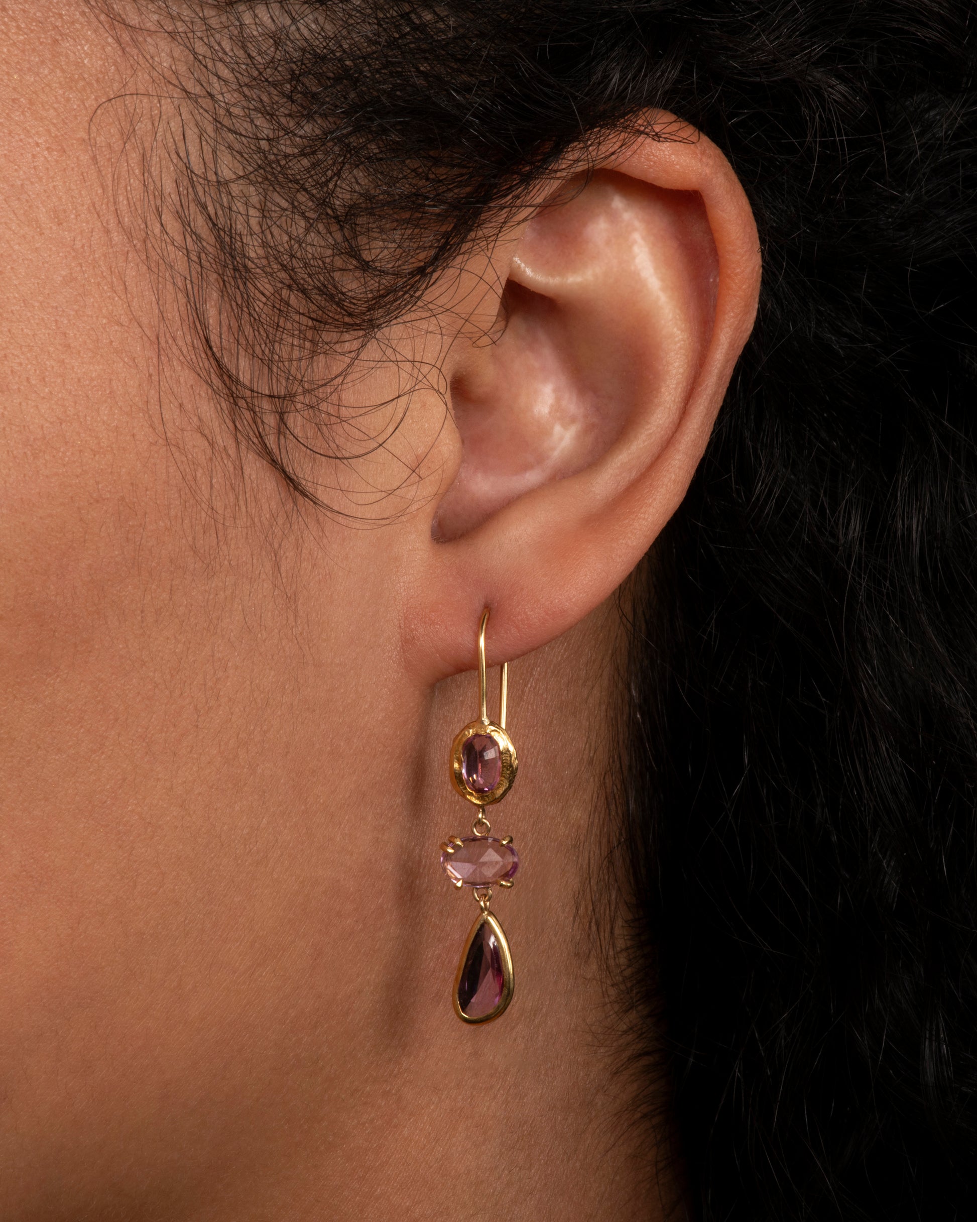 Yellow gold three tier drops with pink sapphires. View on an ear.