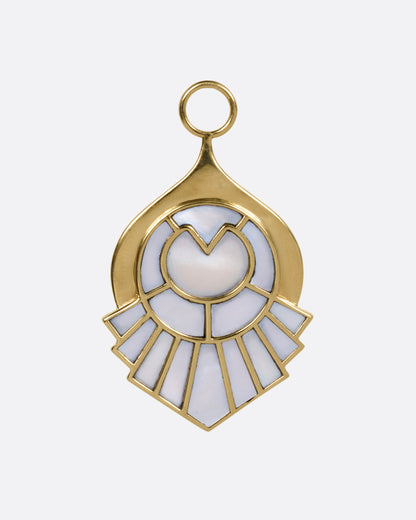 A yellow gold pendant with a feathery plumage design  inlaid with mother of pearl, shown from the front.