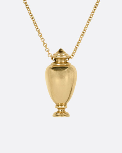 Kathryn Bentley urn pendant necklace in 14k yellow gold, a polished gold urn with a pointed lid on a cable chain