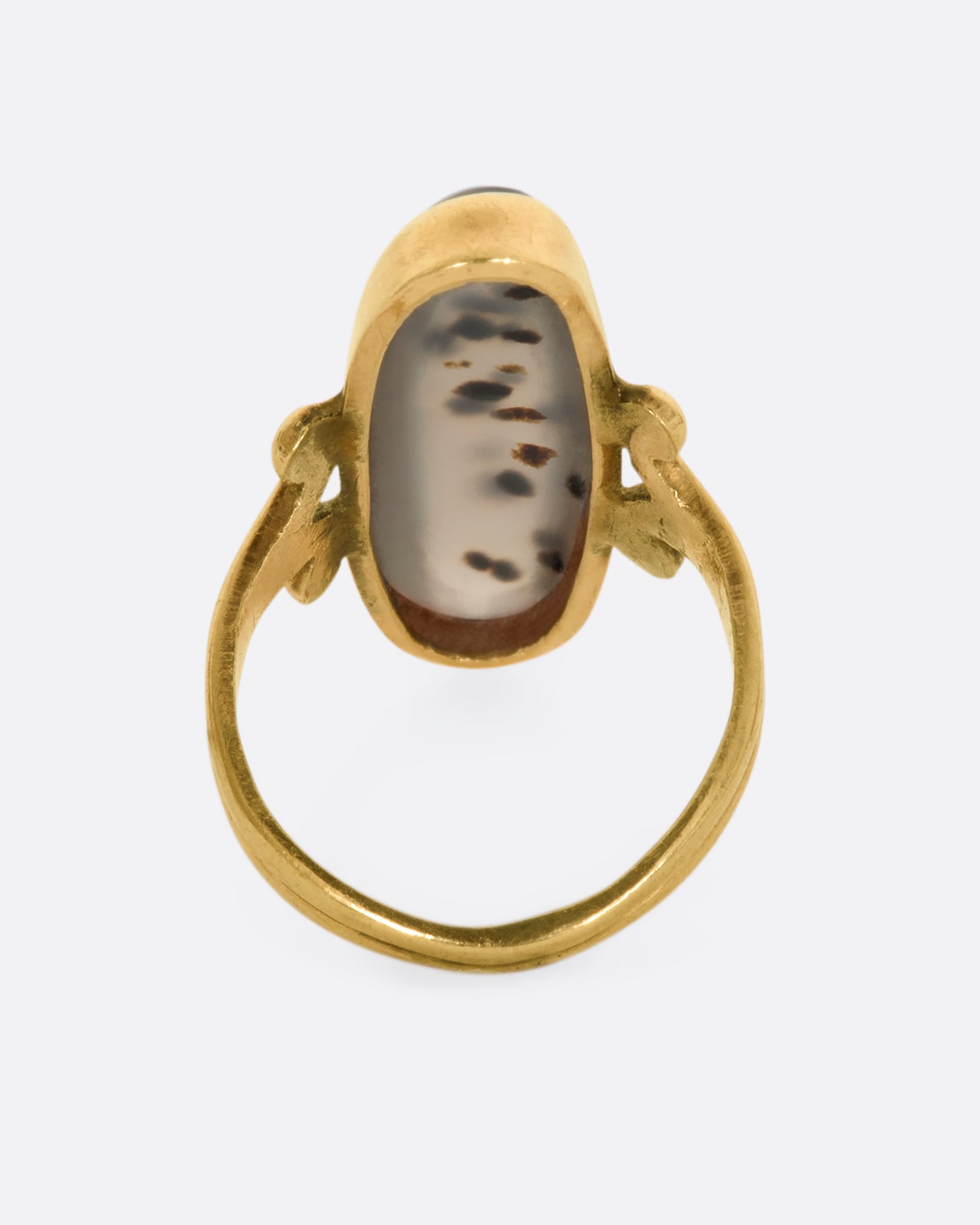 Yellow gold elongated oval agate signet with with swirled shoulders. View from the back.