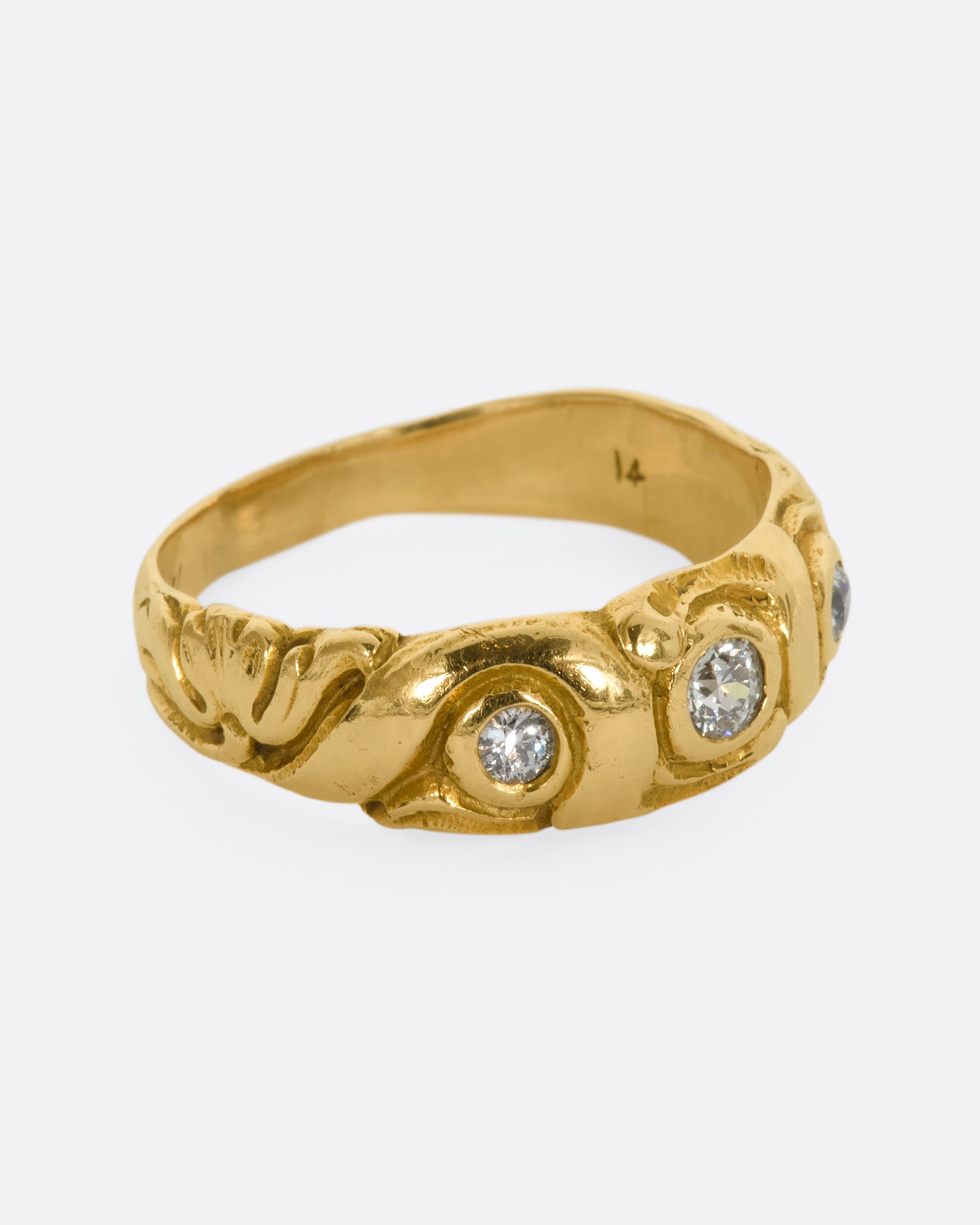 A textured yellow gold ring with three diamonds. View from the alternate side.