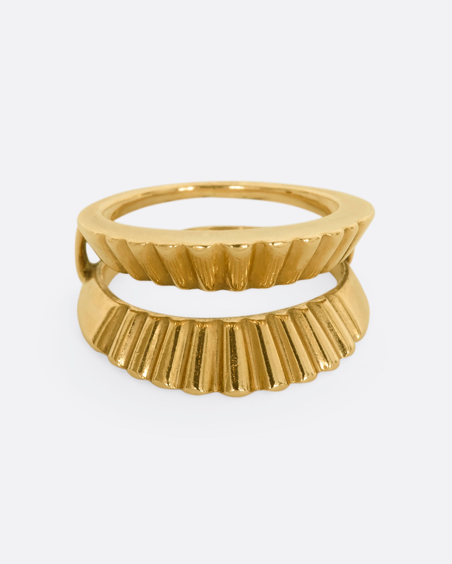 A yellow gold guard ring with a scalloped edge. Shown from the front.