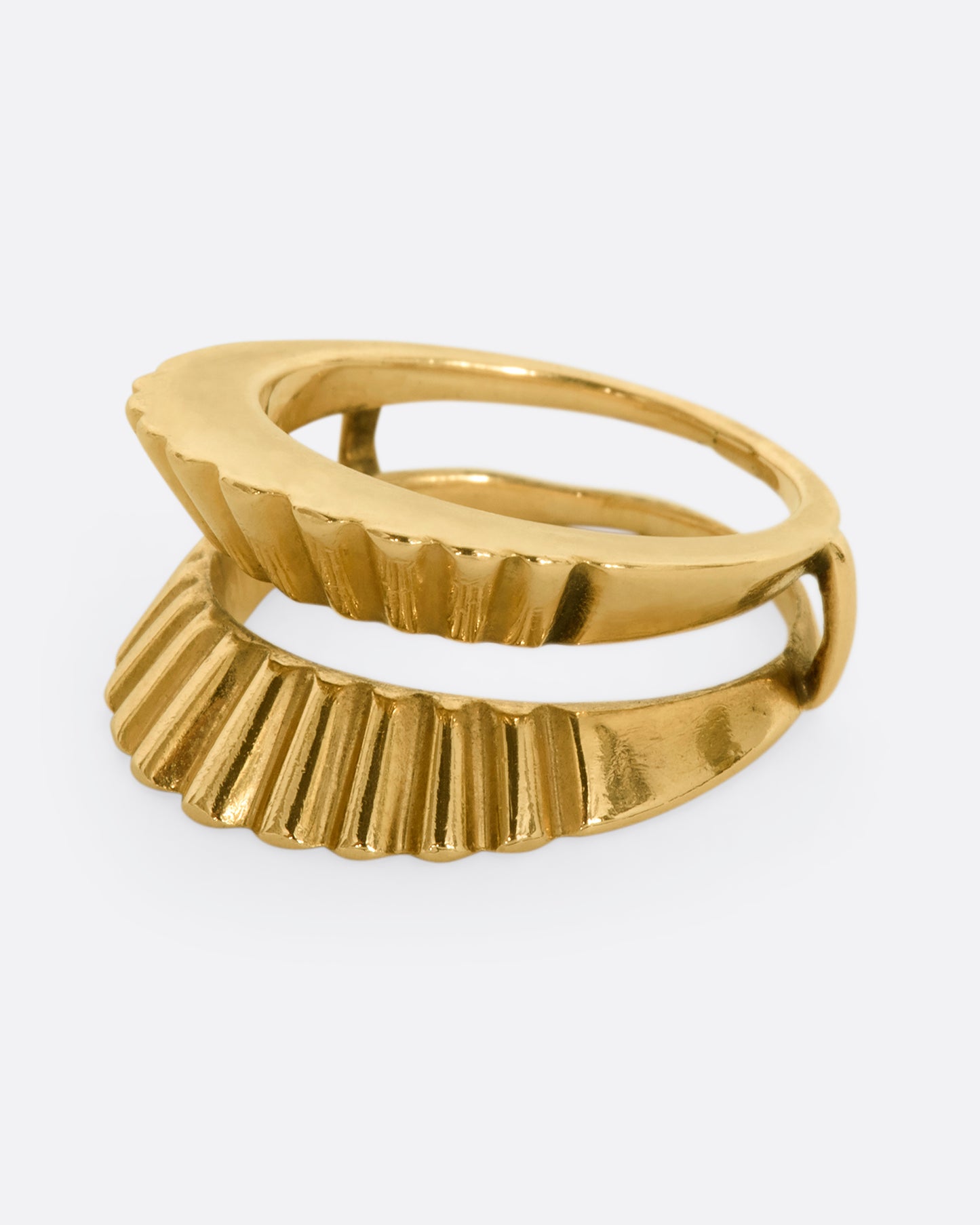 A yellow gold guard ring with a scalloped edge. Shown from the side.