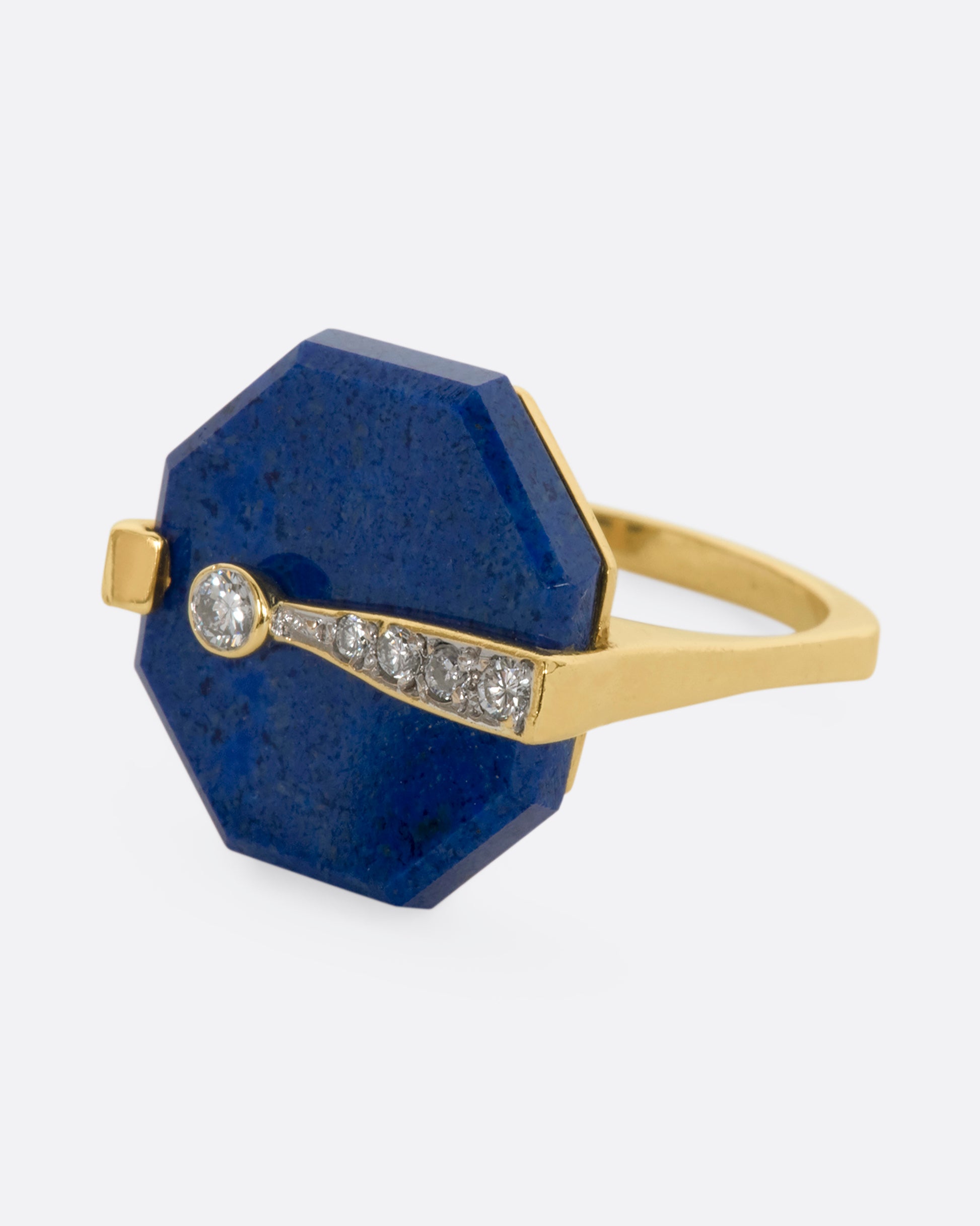 A yellow gold right with an octagonal lapis and diamond exclamation point. View from the side.