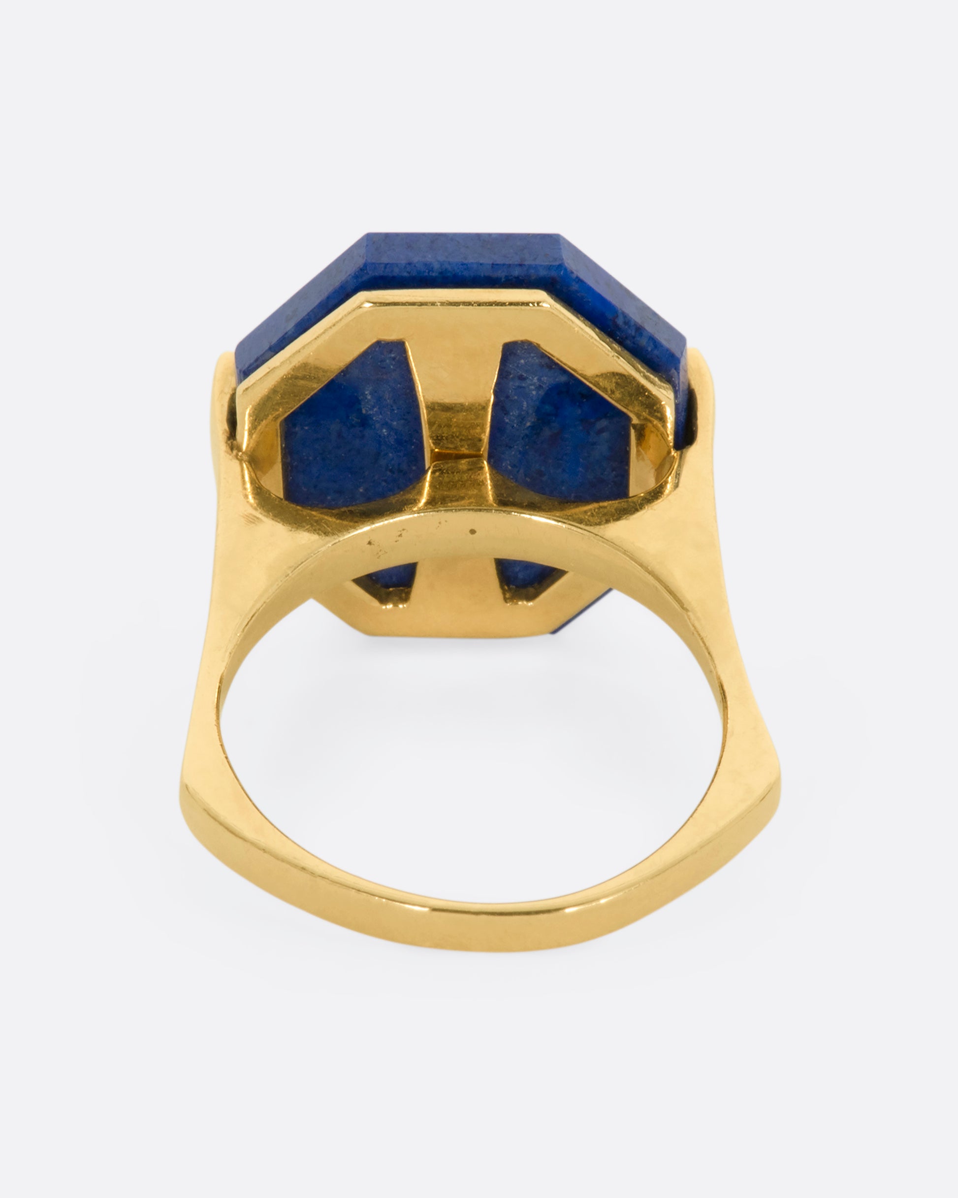 A yellow gold right with an octagonal lapis and diamond exclamation point. View from the back.