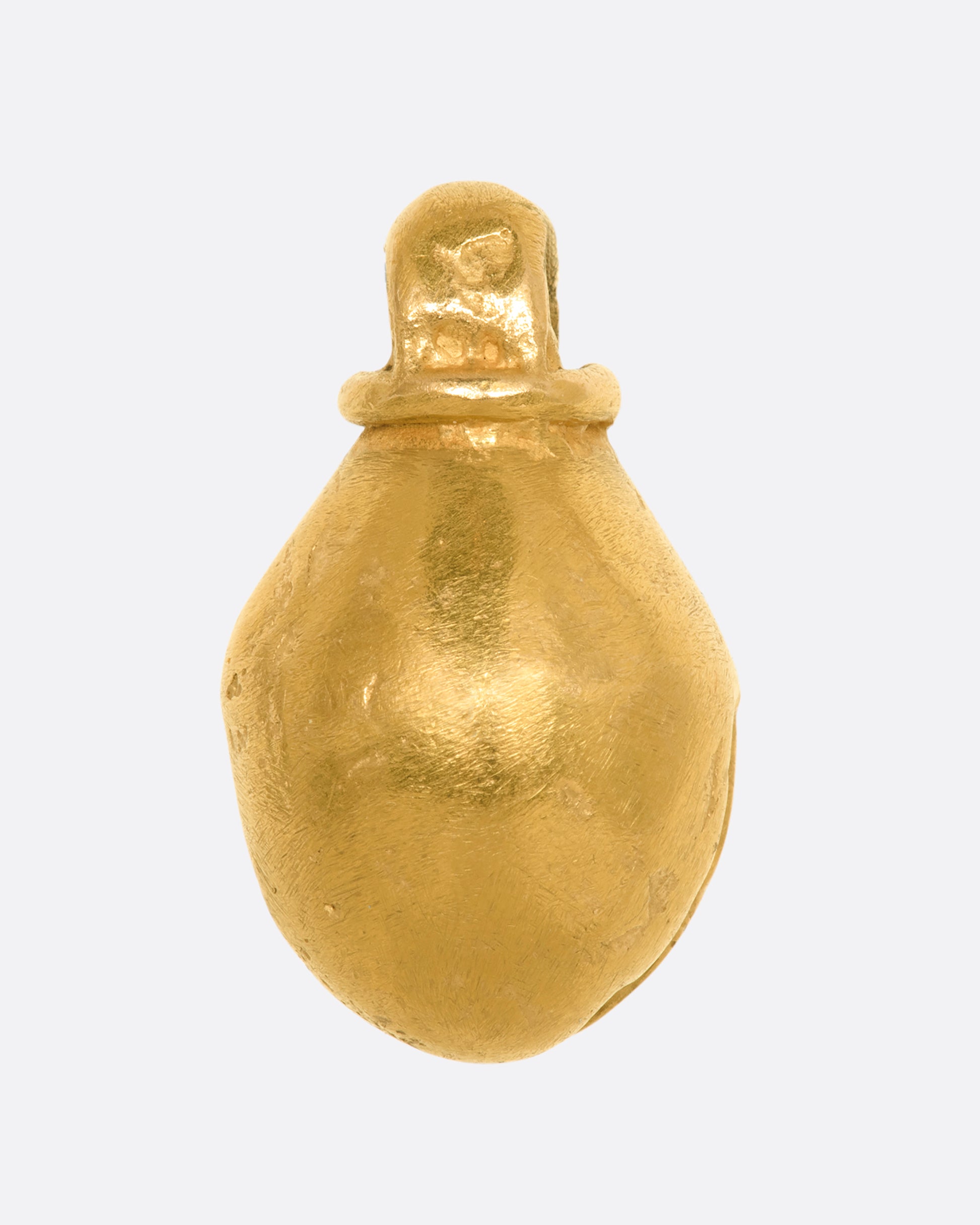 A yellow gold bell charm or pendant. View from the back.