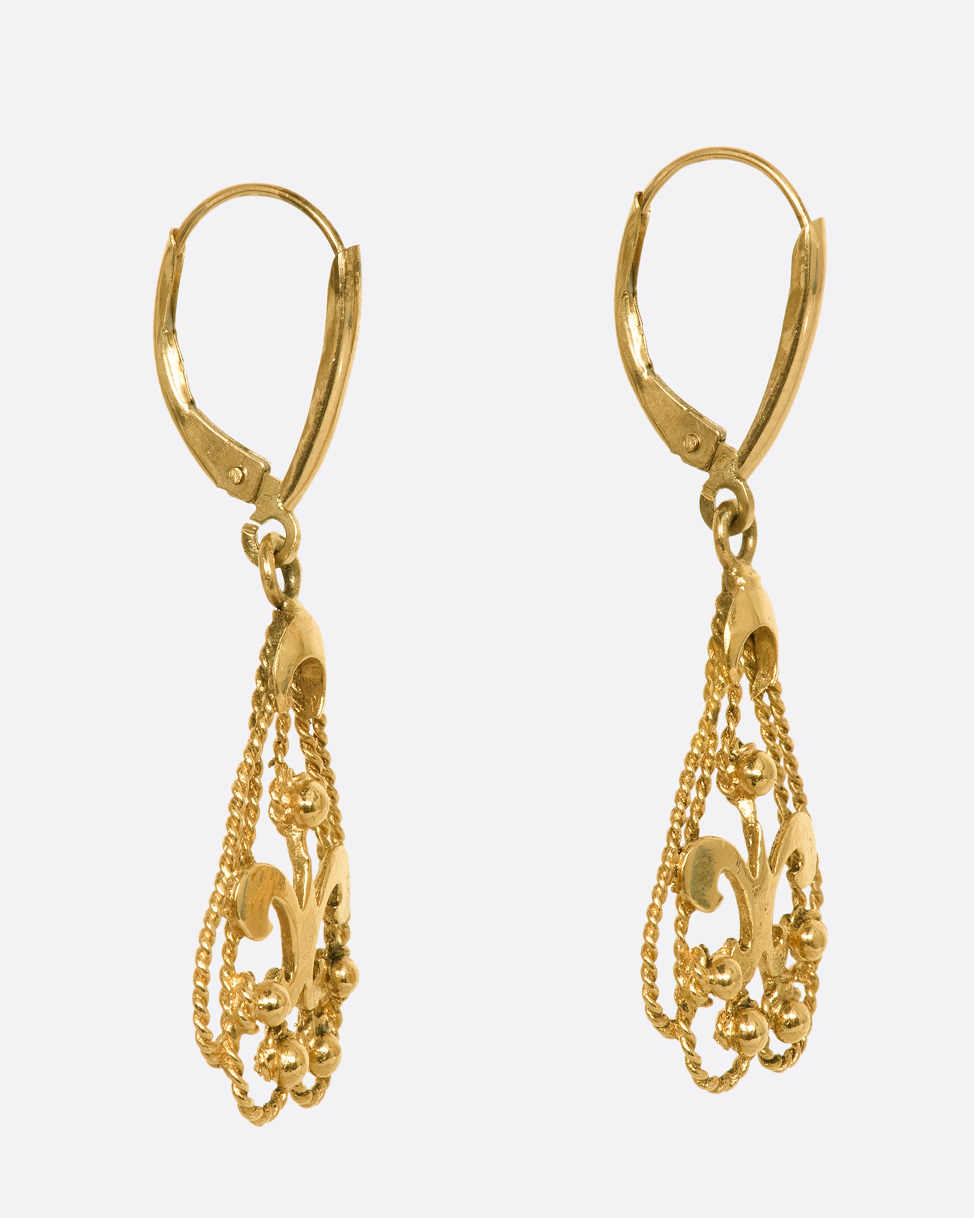 Fleur De Lis lever back drop earrings. View from the side.