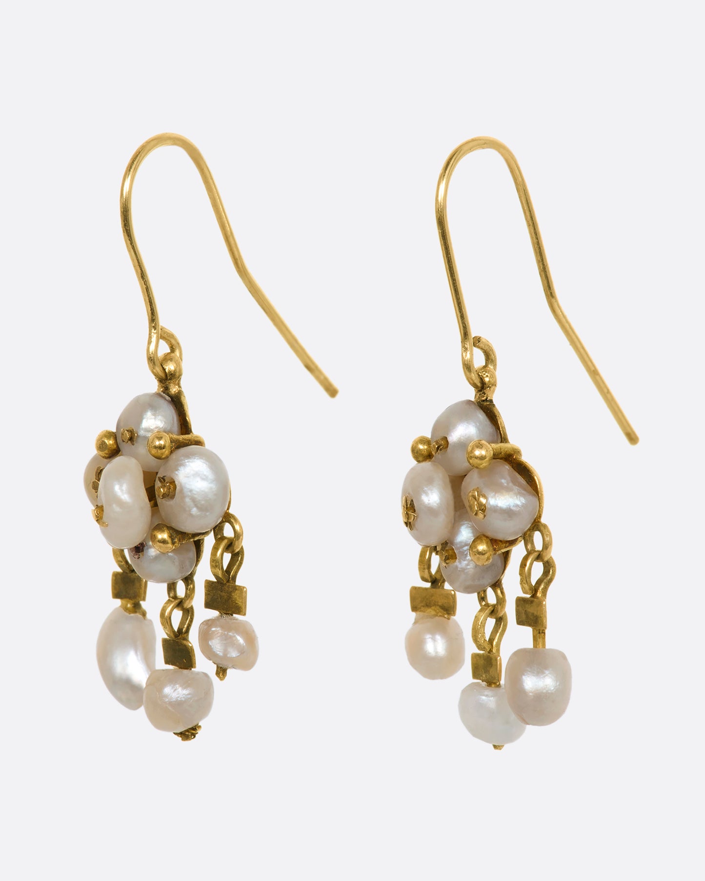 Yellow gold seed pearl chandelier drop earrings. View from the side.