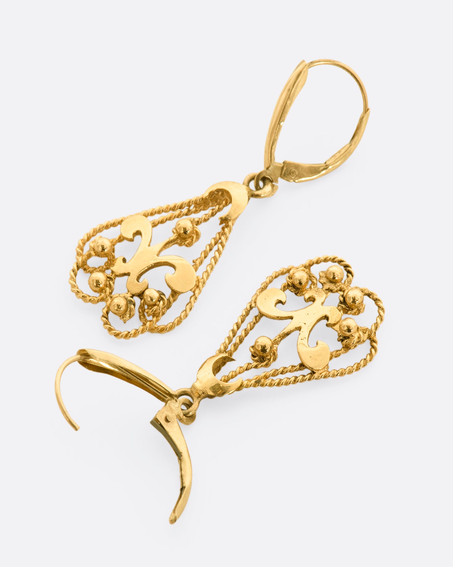 Fleur De Lis lever back drop earrings. View from above, laying flat.