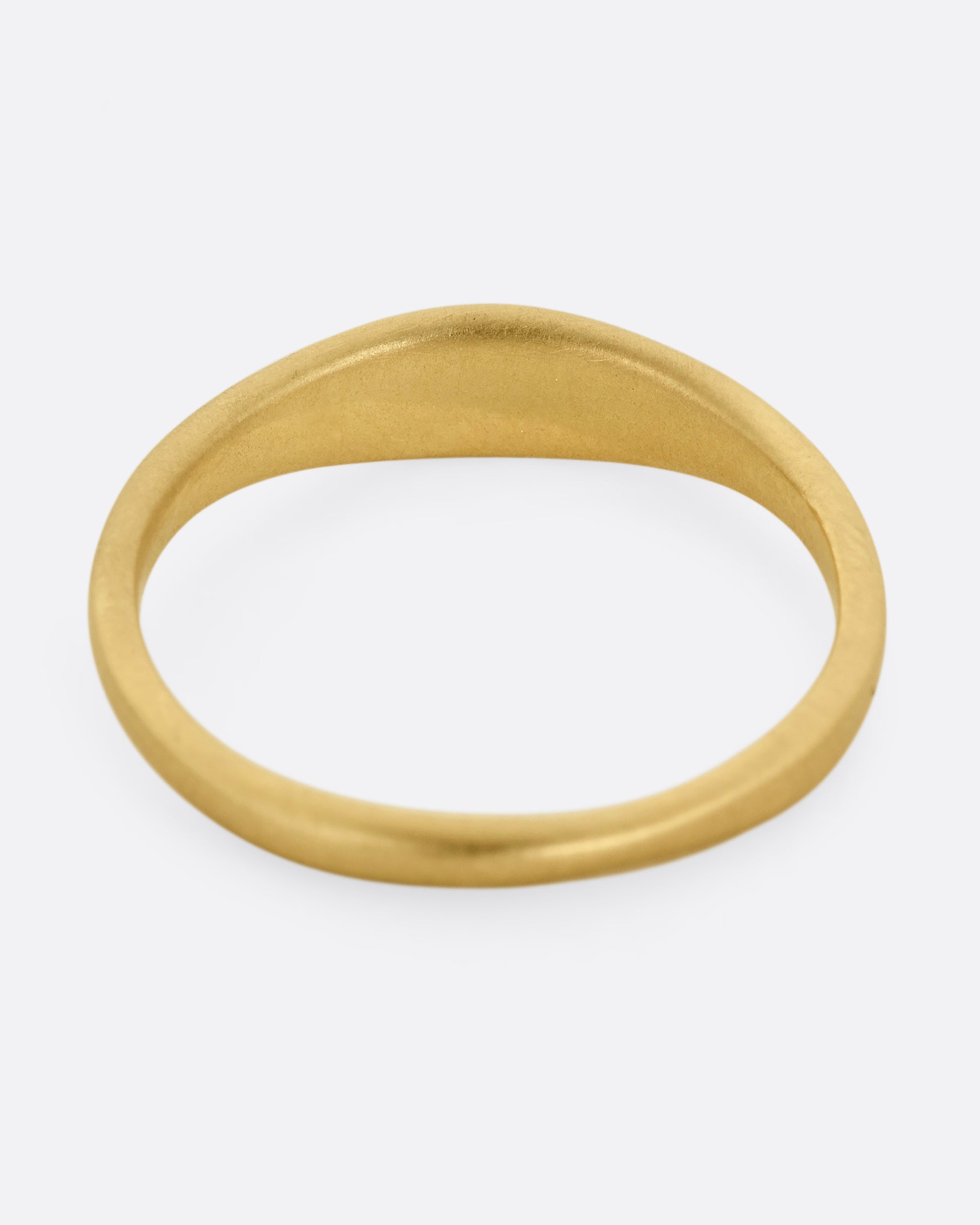 A yellow gold ring with seven diamonds. Shown from the back.
