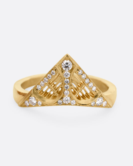 A yellow gold ring with a triangular face, white diamond accents, and cutouts. Shown from the front.
