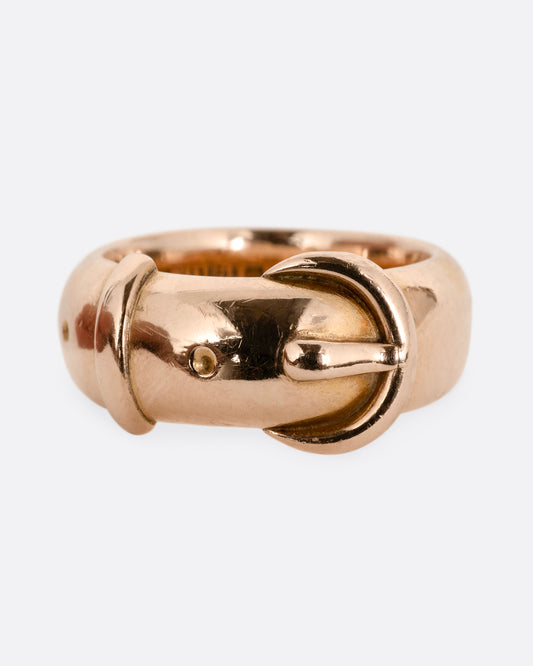 A yellow gold belt buckle ring with a curved edge. Shown from the front.