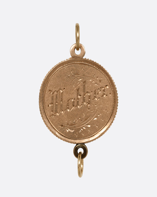 A yellow gold charm with 'Mother' on one side and 'Father' on the other and a jump ring on top and one on bottom. Shown from the 'Mother' side.