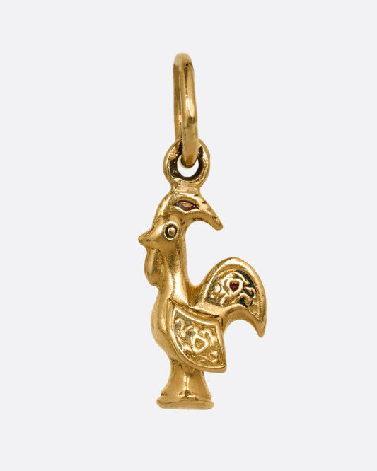 A yellow gold rooster charm shown from the front.