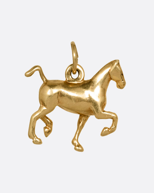 A yellow gold horse charm shown from the front.