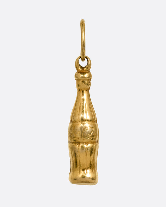 A yellow gold Coca-Cola bottle charm shown from the front.
