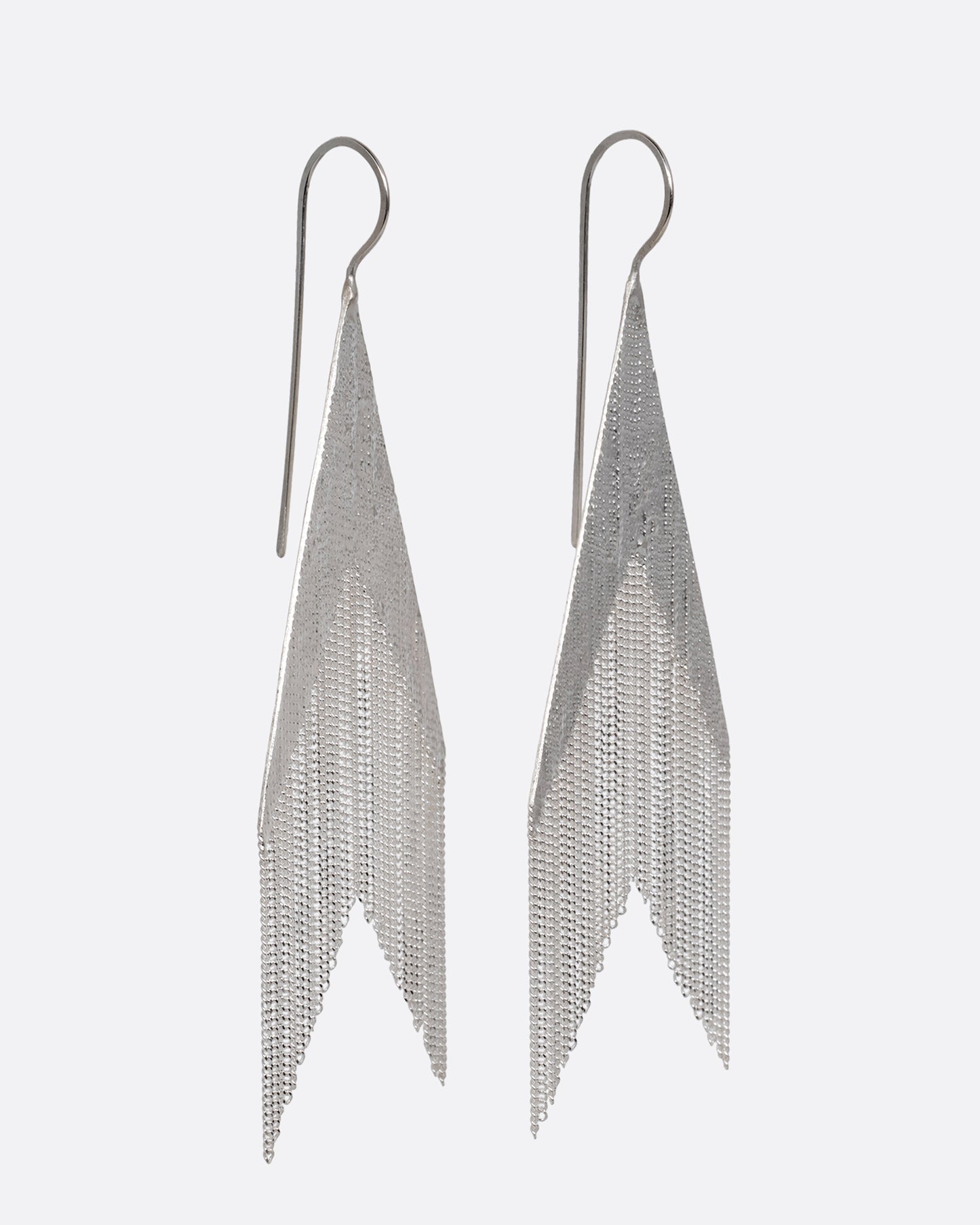 A pair of arrow shaped silver dangle earrings with cable chain fringe. Shown from the side.
