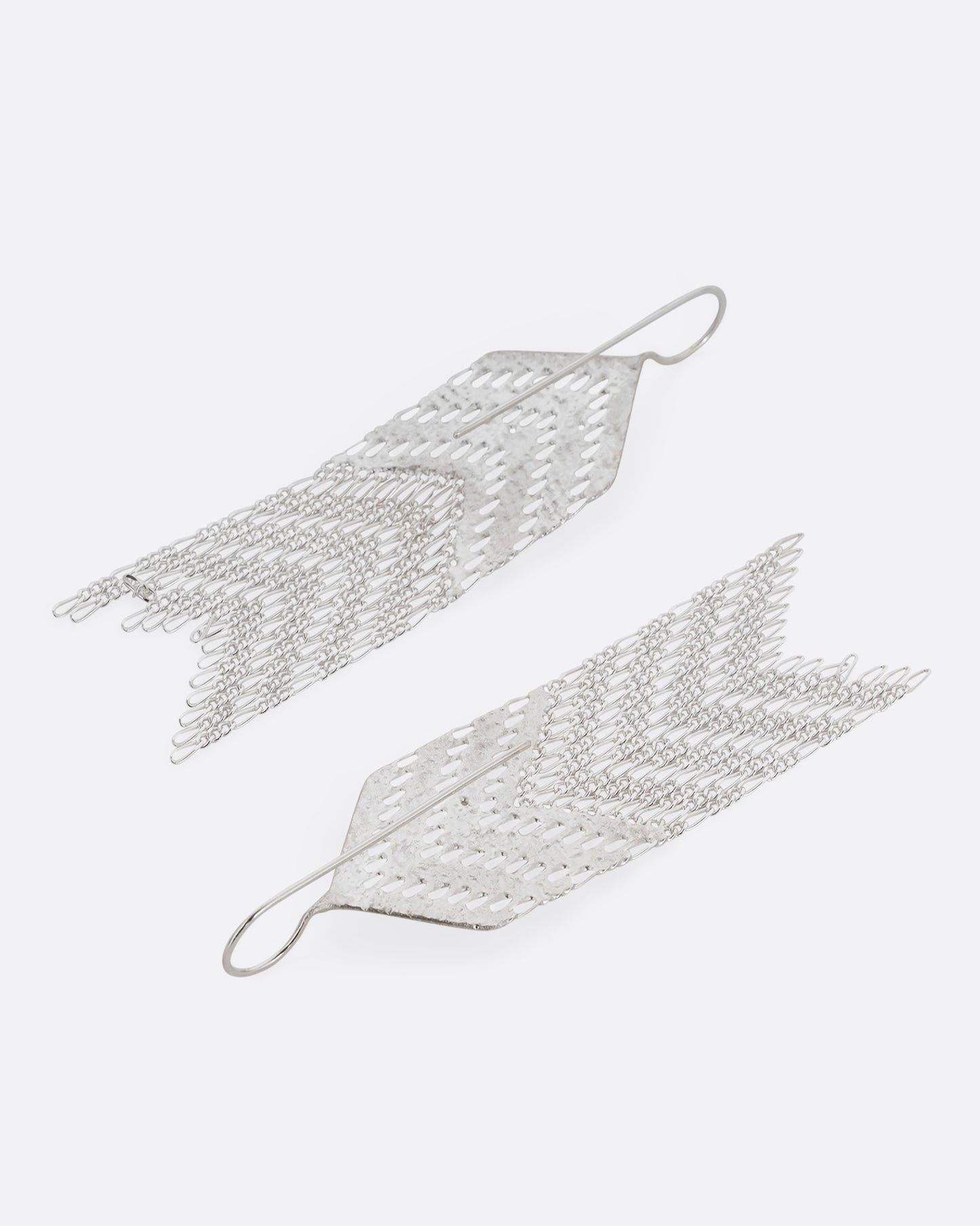A pair of arrow shaped silver dangle earrings with Figaro chain fringe. Shown from the back.