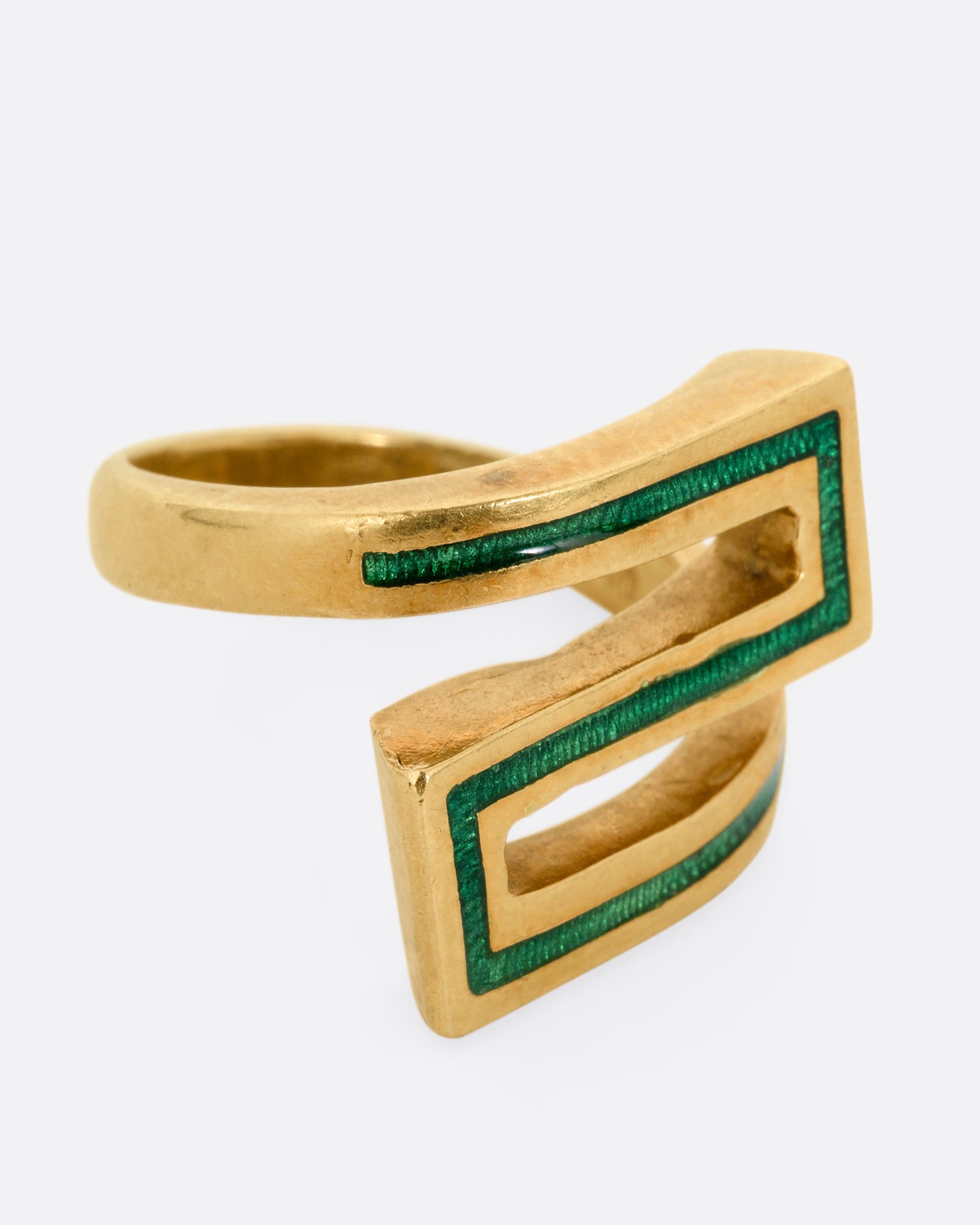 A yellow gold Greek Key ring with a zigzag pattern in green enamel, shown from the side.