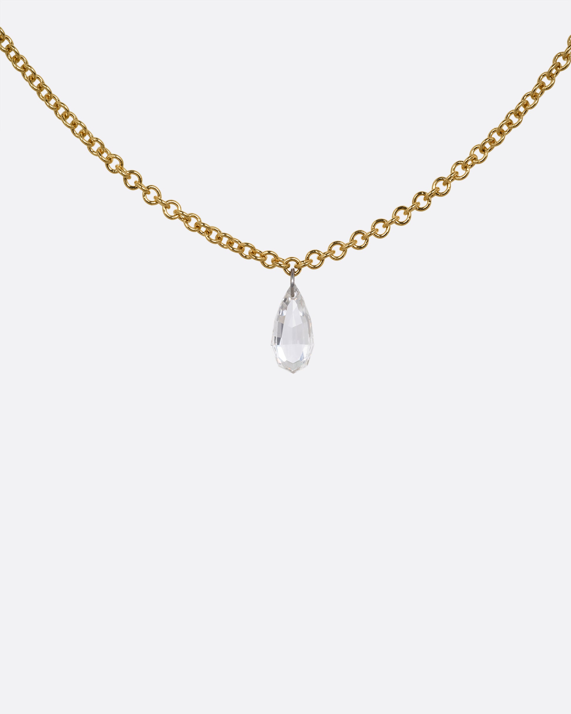 A yellow gold cable chain necklace with a pear shaped diamond. Shown from the front.