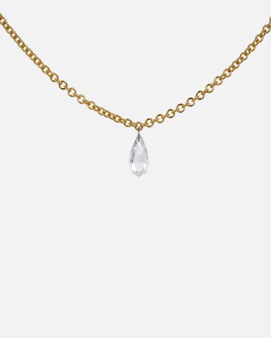 A yellow gold cable chain necklace with a pear shaped diamond. Shown from the front.