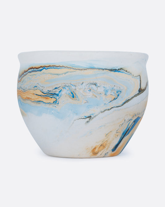A white Nemadji pot with swirls of blues and golds shown from the front.