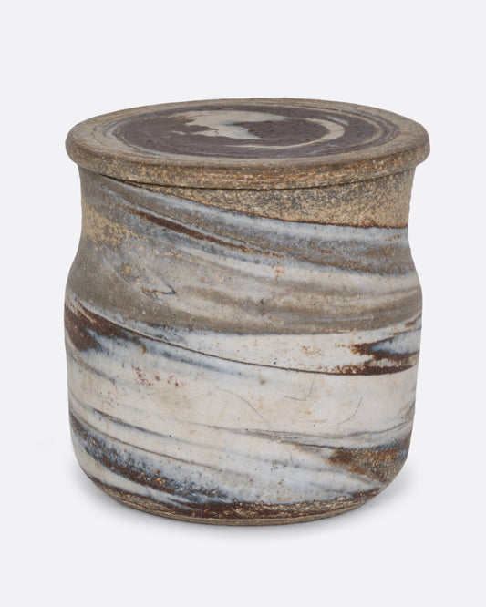 A lidded jar with a gray swirled matte exterior and glazed interior. Shown from the front.