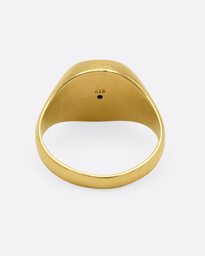 Vintage yellow gold onyx signet ring, back view of the band showing the 18k stamp
