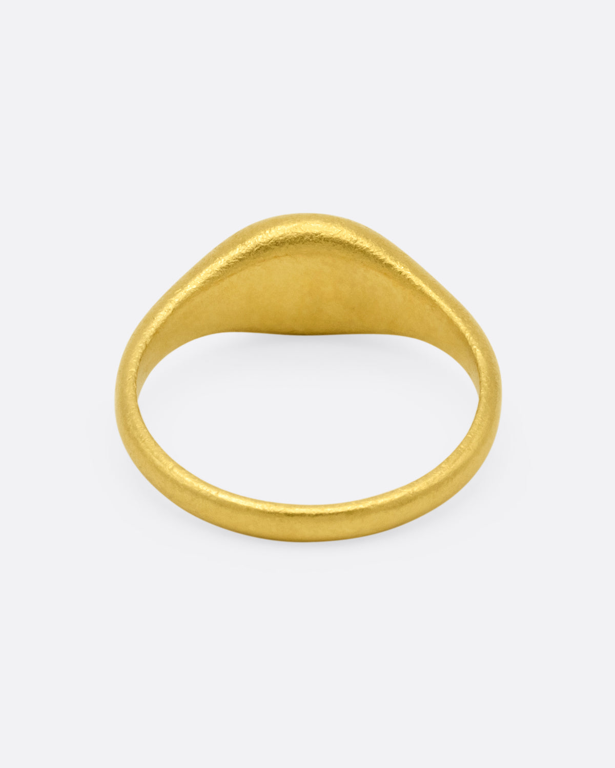 A yellow gold signet ring with a dark green chalcedony carved with a parrot, shown from the back.