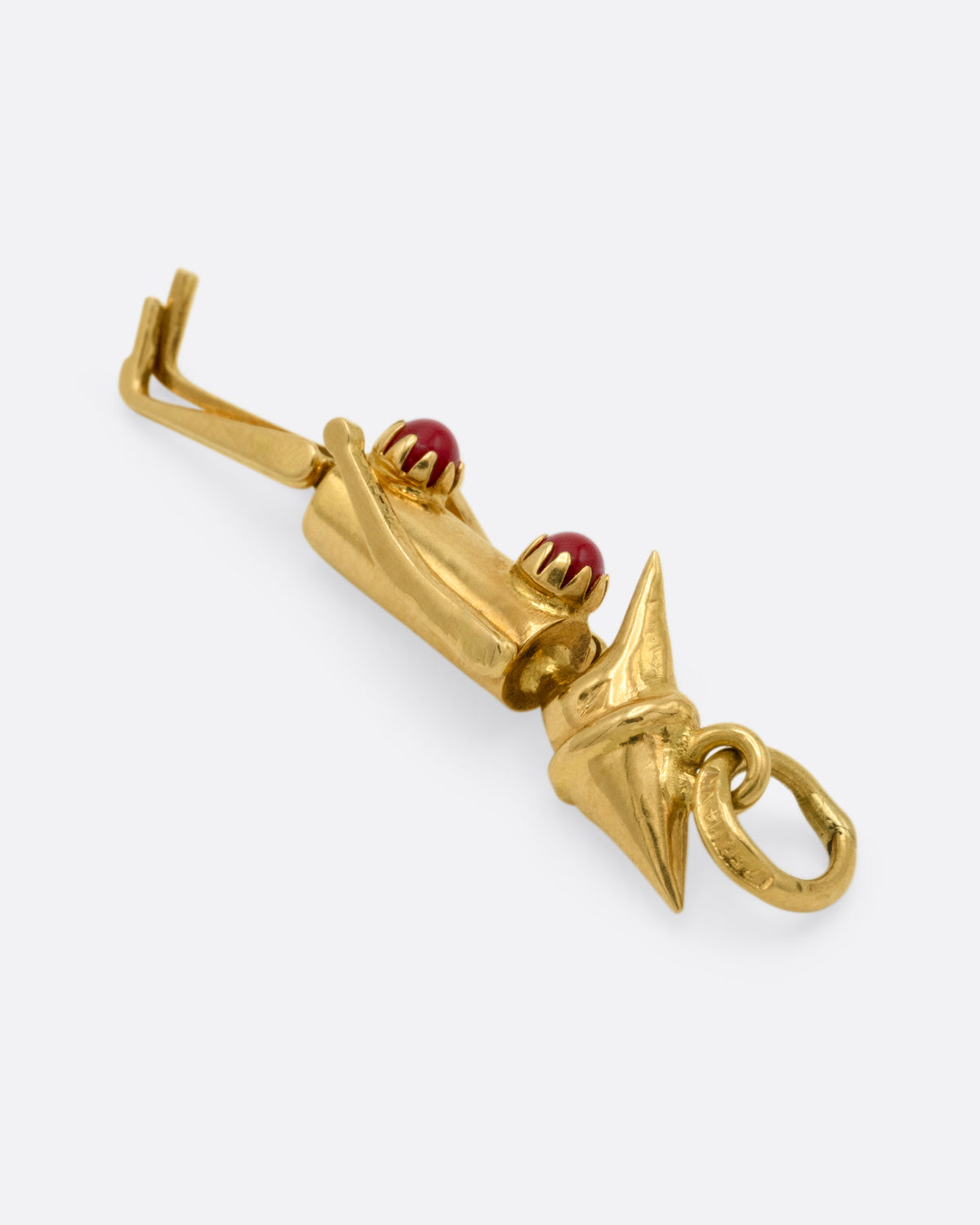  A yellow gold articulated Pierrot clown with two coral 'pom poms' atop his signature costume. Shown from the side.