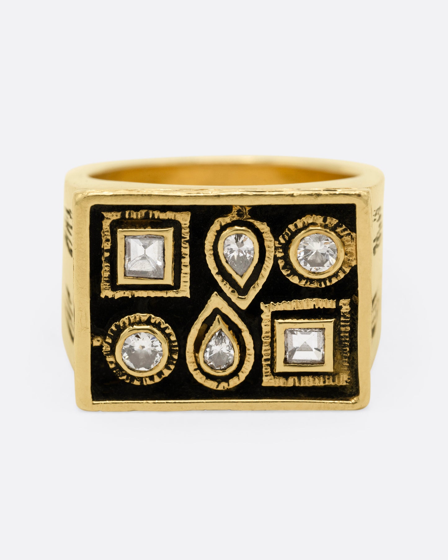 A rectangular yellow gold signet ring with mixed cut diamonds sand textured stone settings and shoulders, shown from the front.
