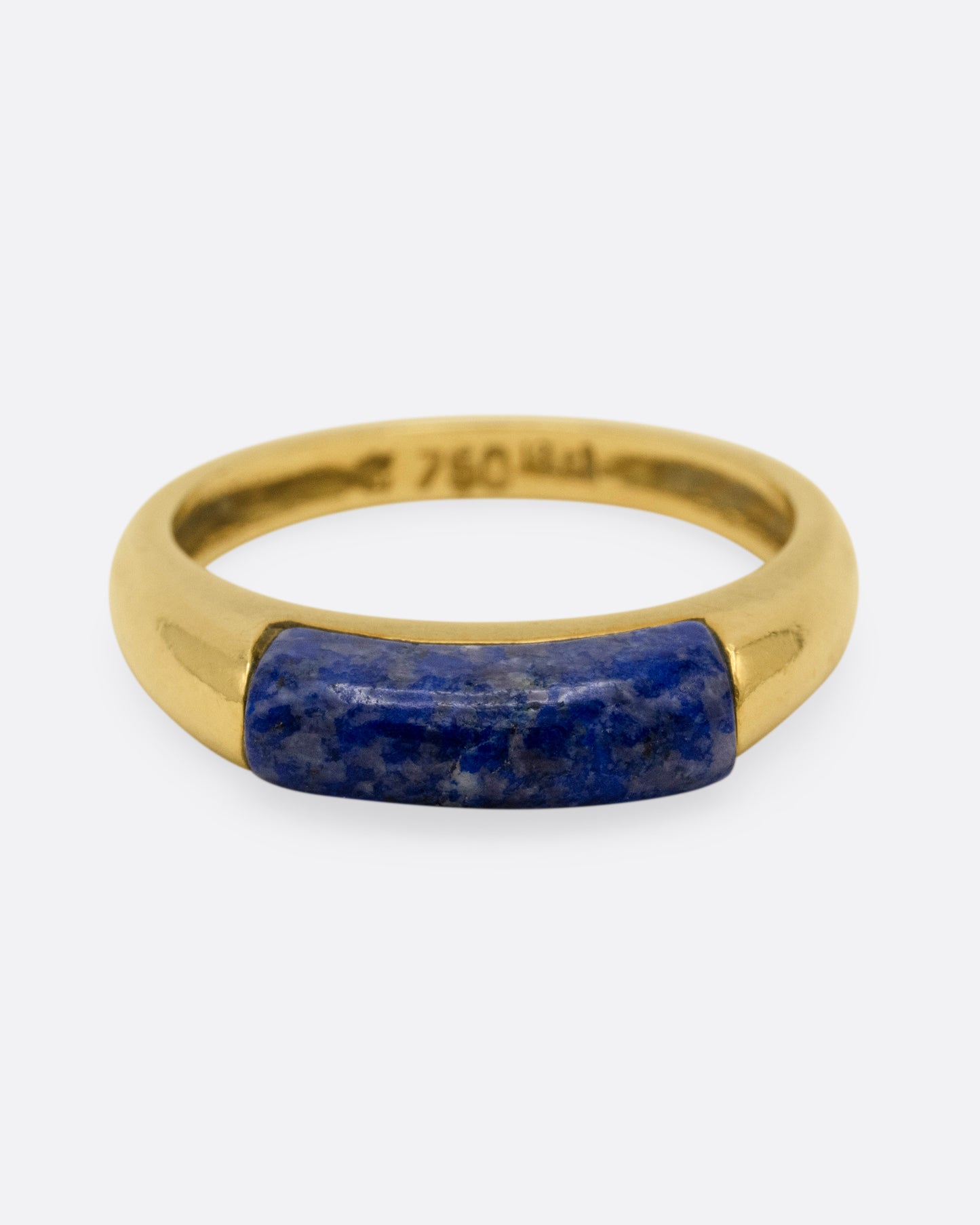A yellow gold signet ring with a rounded silhouette and bar of lapis, shown from the front.