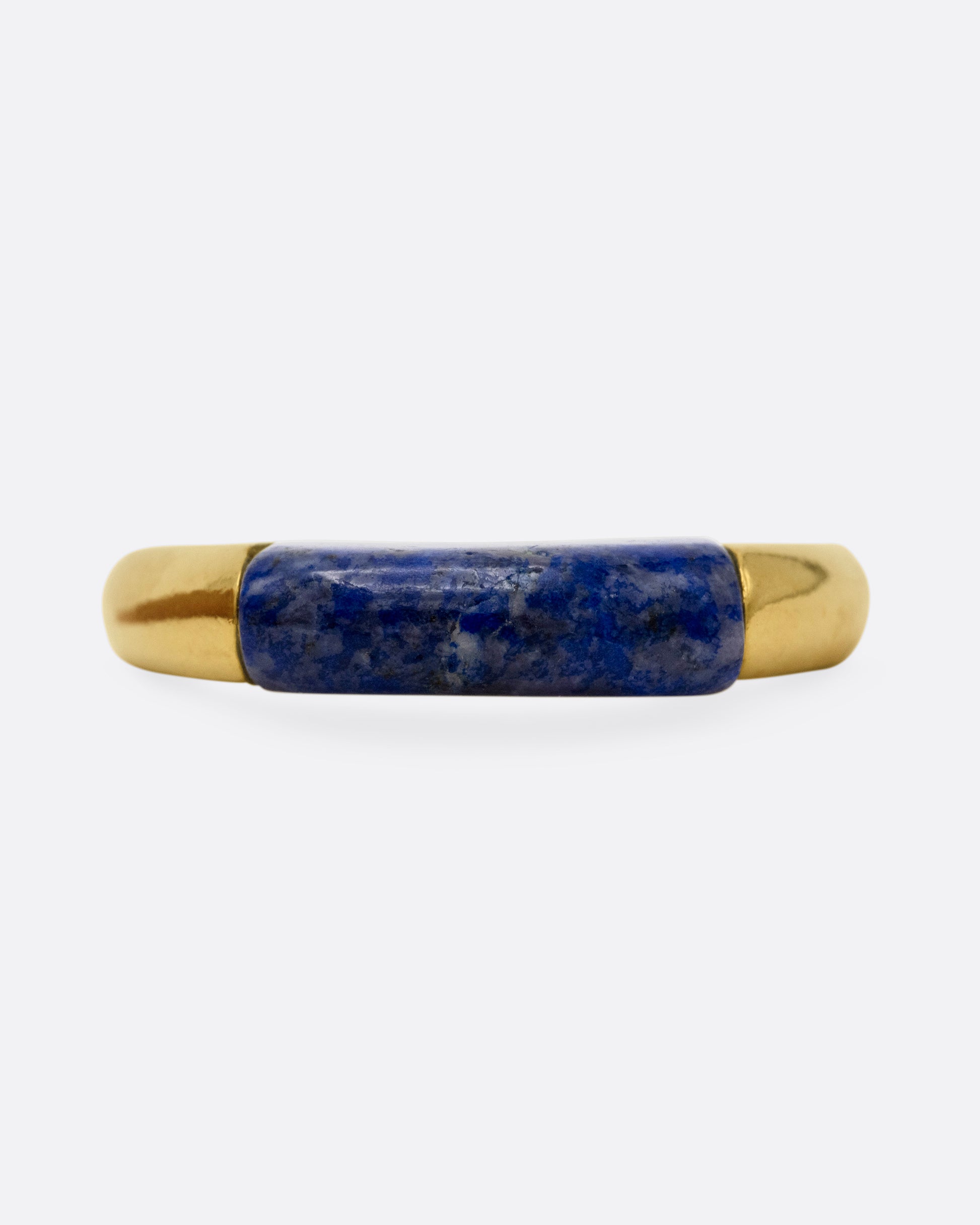 A yellow gold signet ring with a rounded silhouette and bar of lapis, shown from the front.