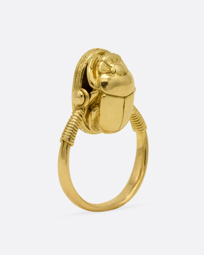An Egyptian revival (c.1860) yellow gold scarab shaped ring, shown from the side.