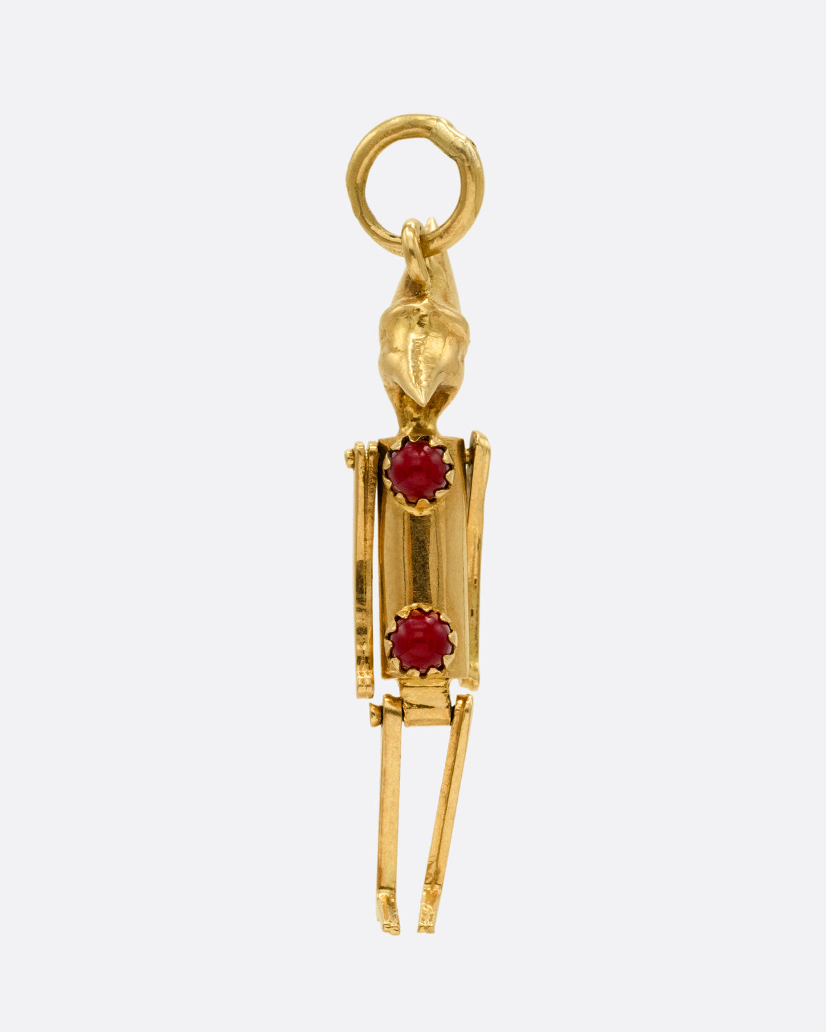  A yellow gold articulated Pierrot clown with two coral 'pom poms' atop his signature costume. Shown from the front.