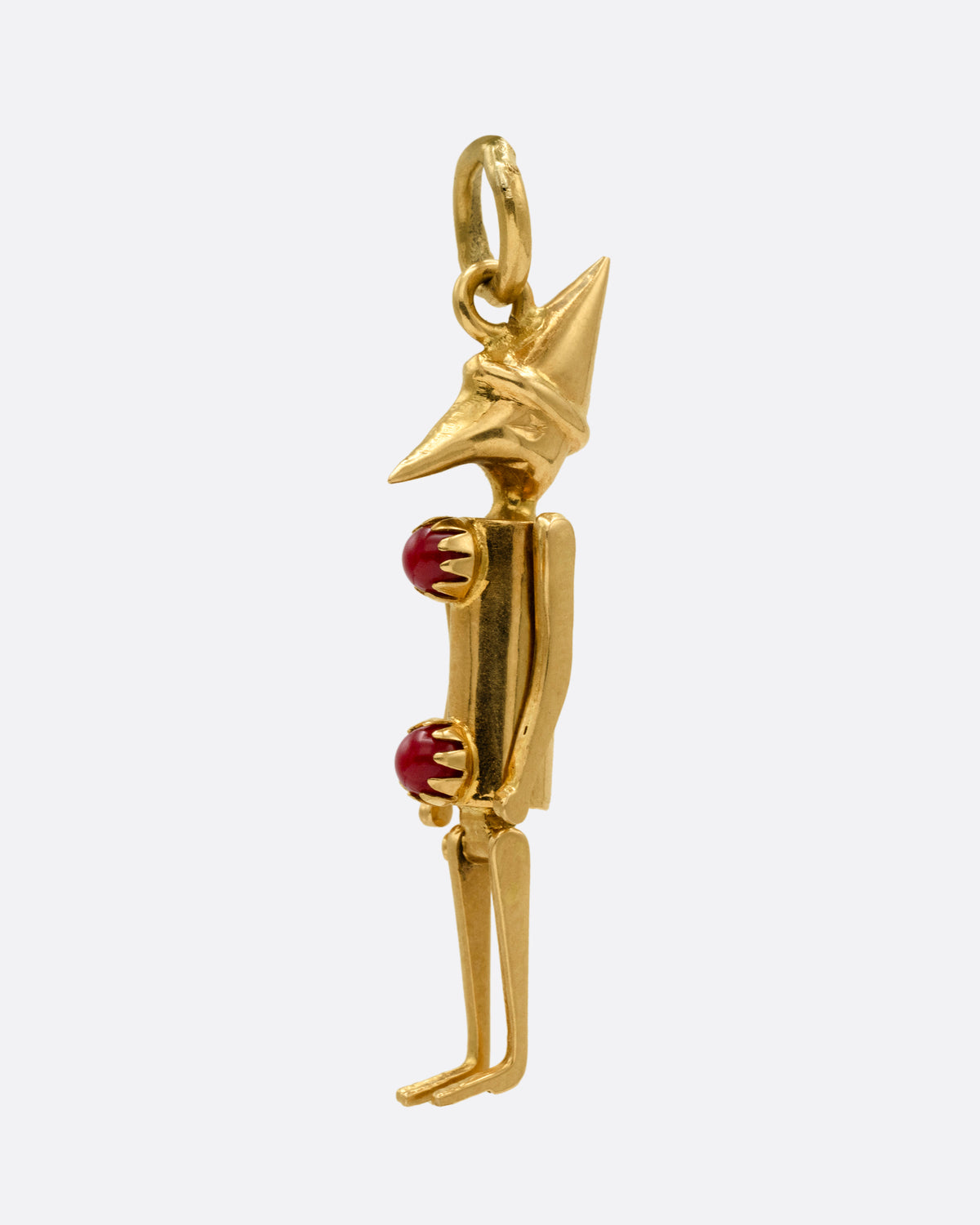  A yellow gold articulated Pierrot clown with two coral 'pom poms' atop his signature costume. Shown from the side.