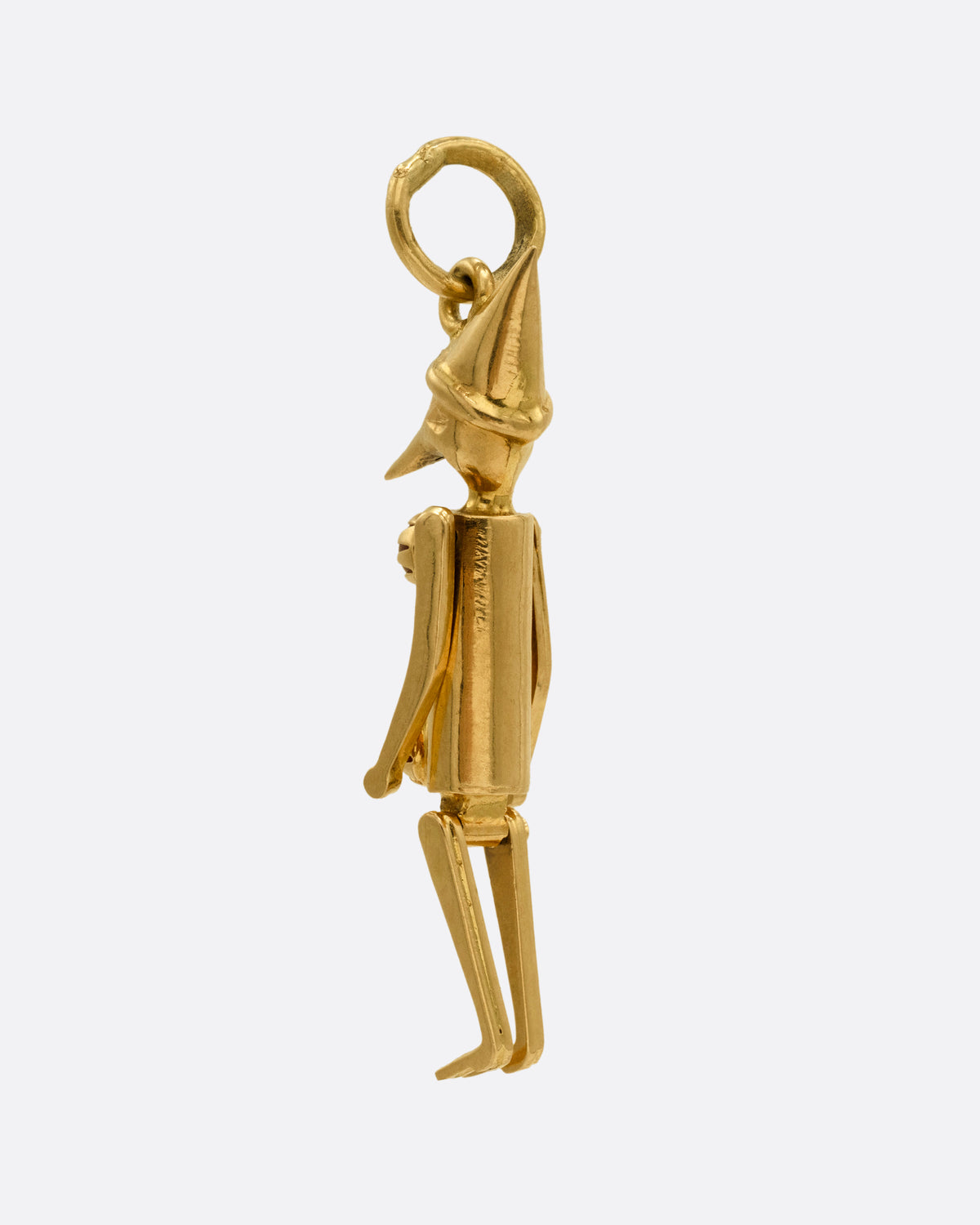  A yellow gold articulated Pierrot clown with two coral 'pom poms' atop his signature costume. Shown from the back.