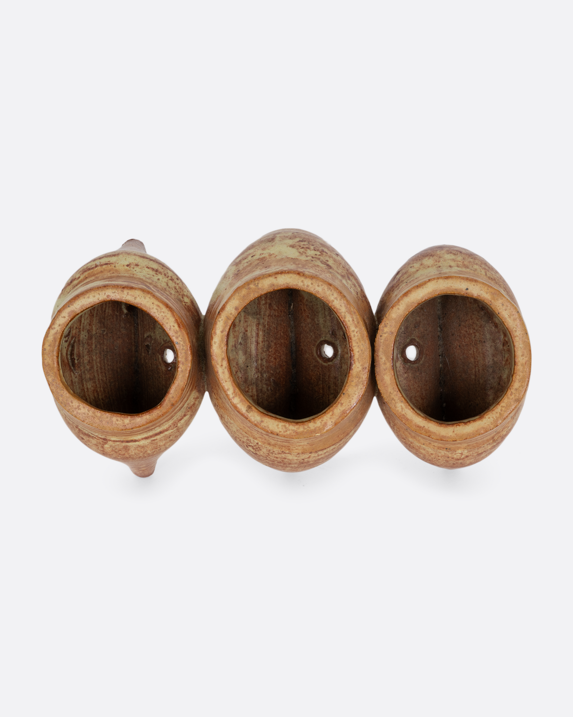 Three connected planters with pinched bottoms, drainage holes, and feet. Shown from the top.