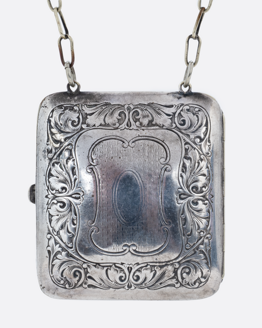 A silver square velvet lined coin purse with a cable wrist chain. Shown from the front.