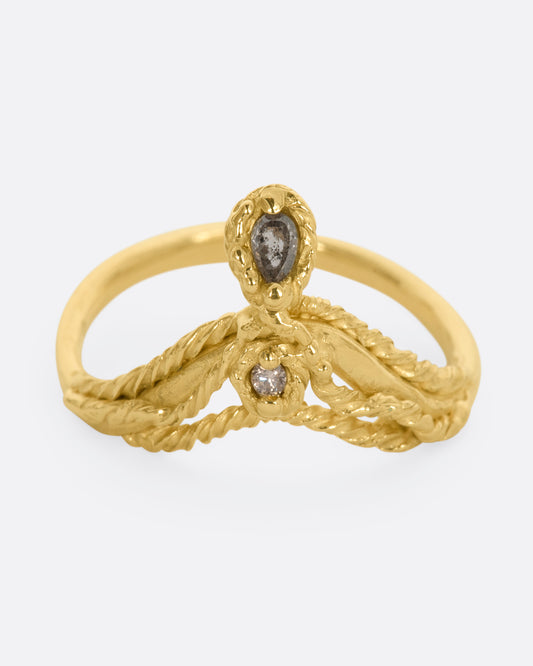 A yellow gold tiara shaped ring with twisted gold details, a rose cut salt and pepper tear drop diamond and a brilliant cut champagne diamond. View from the front.