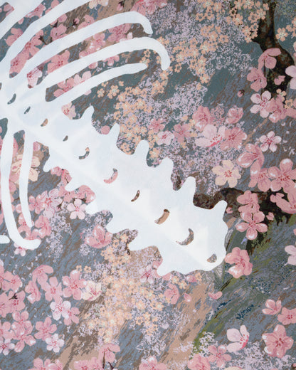A close up of a button front short sleeve shirt with a cherry blossom print punctuated by Kapital’s skeleton motif, shown from the back.